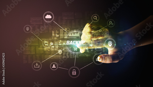 Hand touching BACKUP inscription, Cybersecurity concept