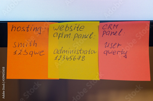 A very weak and widespread password is written on a sticker / stick note attached to a computer monitor. Password Security Weakness Concept. Typical information security failures. Bad password policy.