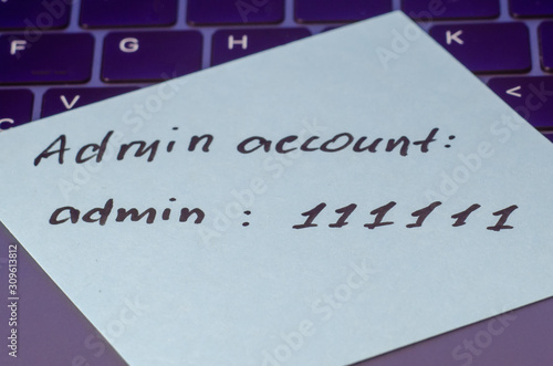 A very weak, simple and widespread password is written on a sticker that lies on the laptop keyboard. Password Security Weakness Concept. Bad password. Typical information security failures. 