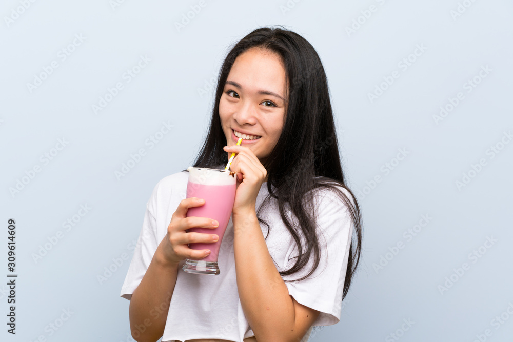Teenager asian girl holding a strawberry milkshake Teenager asian girl holding a strawberry milkshake