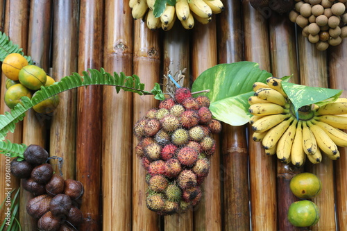 there are various kinds of fruits with a wooden background.