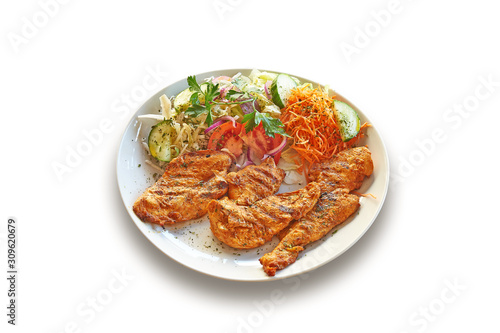 White plate with delicious Chicken filet meat and salad