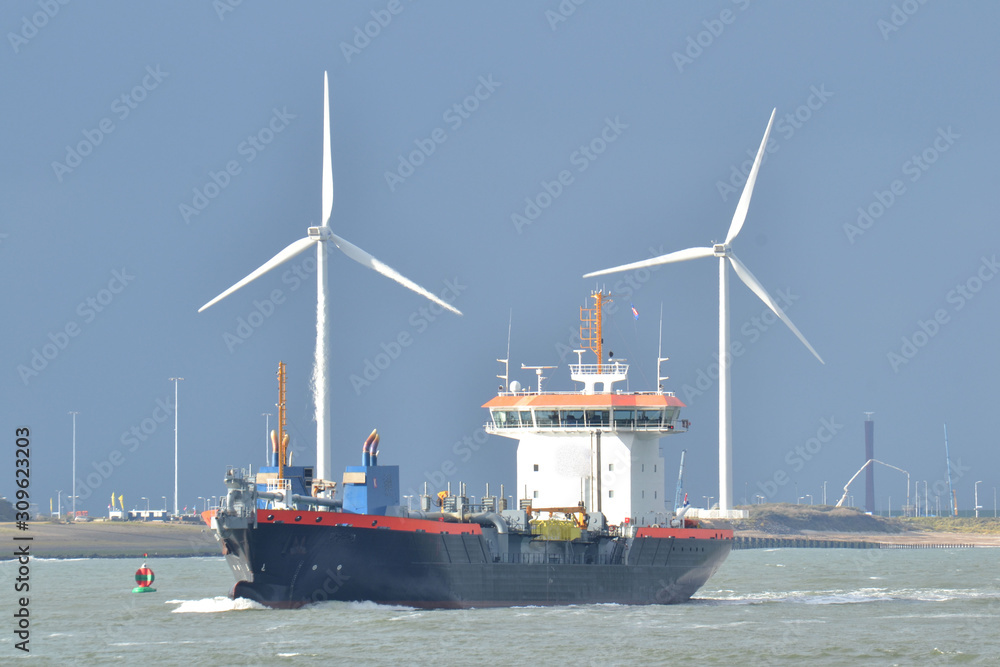 windmills and boat in Nieuwe Waterweg near beach Hoek van Holland windmills and boat in Nieuwe Waterweg near beach Hoek van Holland