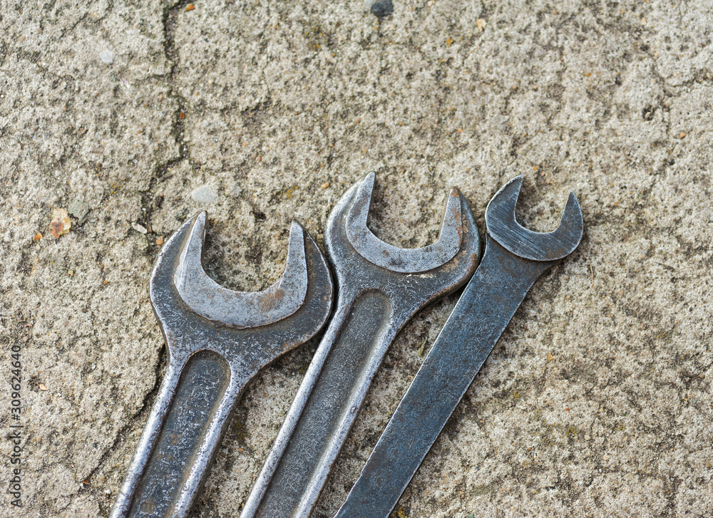 wrenches lying on cracked asphalt wrenches lying on cracked asphalt