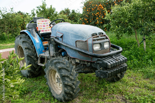 Old blue tractor on the garden meadows