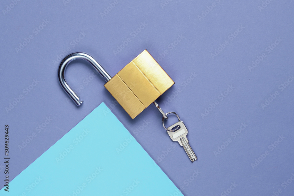 Lock and key on purple-blue background. Minimalistic concept. Top view Lock and key on purple-blue background. Minimalistic concept. Top view