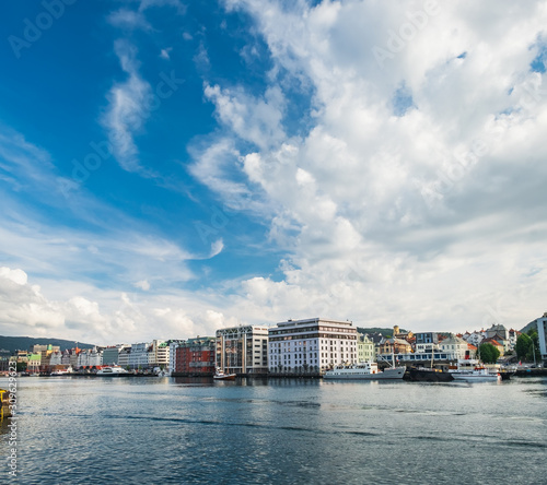 Scenic summer panoramic view of the modern pier architecture, beautiful waters of Byfjorden and cloudy blue sky in Bergen, Norway