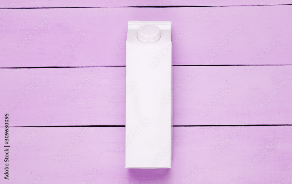 White cardboard box of yogurt on pink wooden background. Minimalistic eco food concept White cardboard box of yogurt on pink wooden background. Minimalistic eco food concept