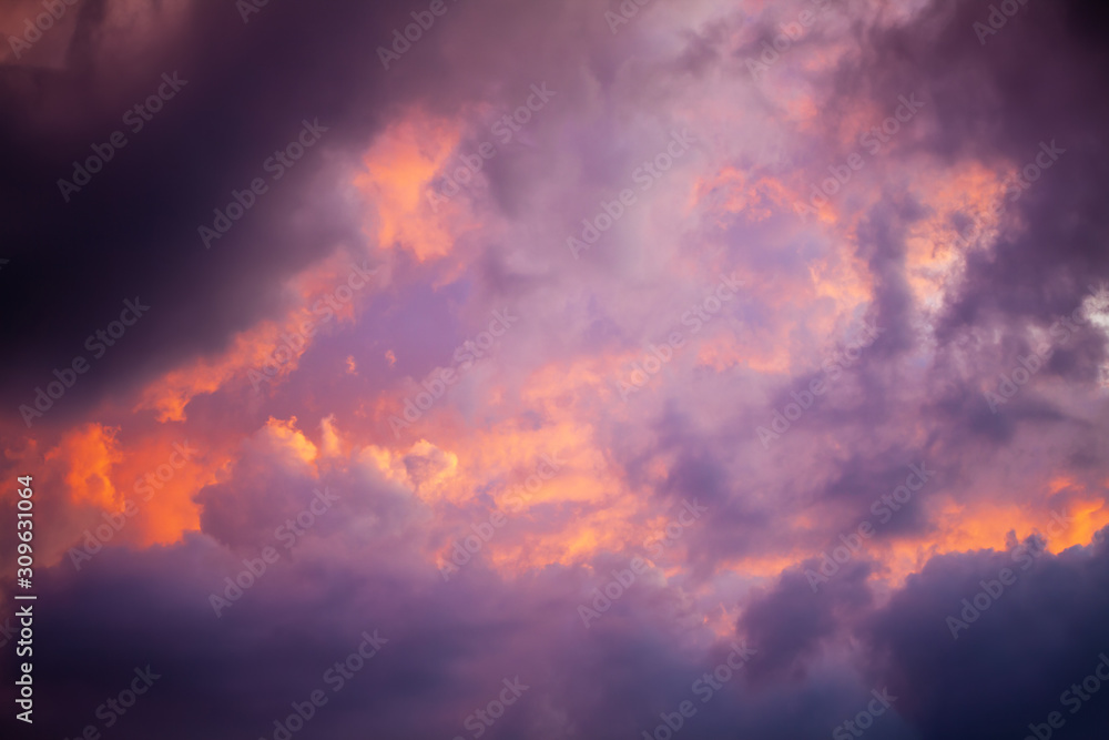 Unusual dramatic clouds of purple, orange and pink at sunset. The sky before the storm. Natural abstract background. Unusual dramatic clouds of purple, orange and pink at sunset. The sky before the storm. Natural abstract background.