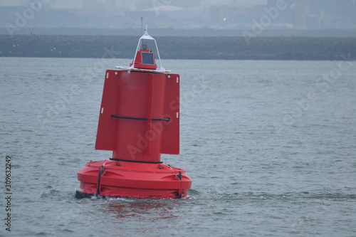 red buoy in the Nieuwe Waterweg near beach Hoek van Holland photo