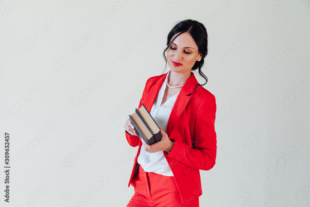 Portrait of a beautiful business woman brunette with in a red business suit Portrait of a beautiful business woman brunette with in a red business suit