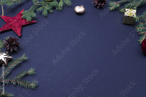 Christmas tree branchers, balls, candy on black background, preparing for the New year. top view, copy spase, mock up