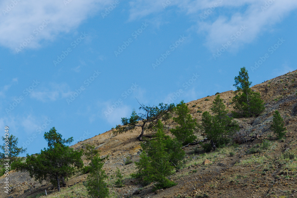 Rocks under blue sky. Sunny day in mountain valley. Colorful hills, Hiking in summer