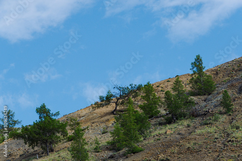 Rocks under blue sky. Sunny day in mountain valley. Colorful hills, Hiking in summer