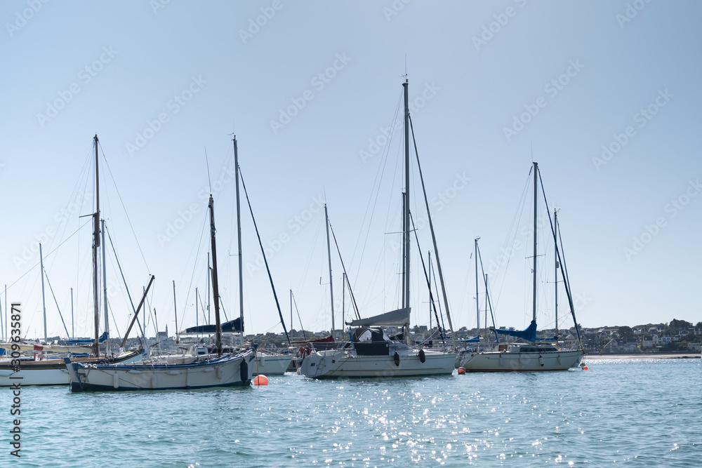 sailing boats moored to buoys in the port of Erquy in Brittany