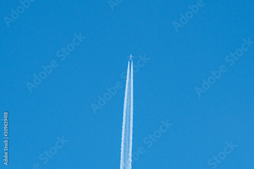 trail of plane flying in blue sky