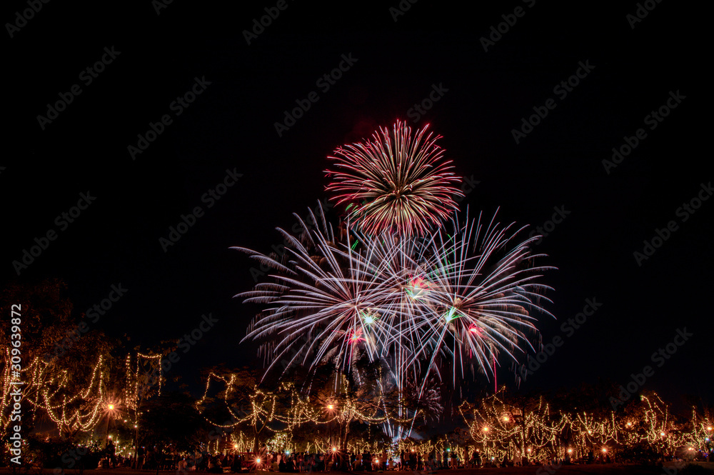 Multicolored bright festive fireworks in the dark sky background.Beautiful colorful fireworks for celebration holiday concept. 