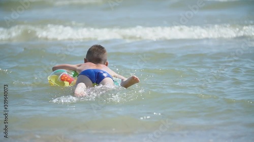 a boy with a circle swims