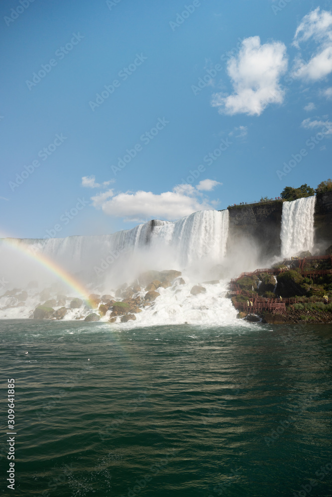 Niagara Falls with rainbow and tourists Niagara Falls with rainbow and tourists