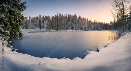 Scenic snow landscape with frozen lake and beautiful sunset at mood winter morning in Finland © Jani Riekkinen