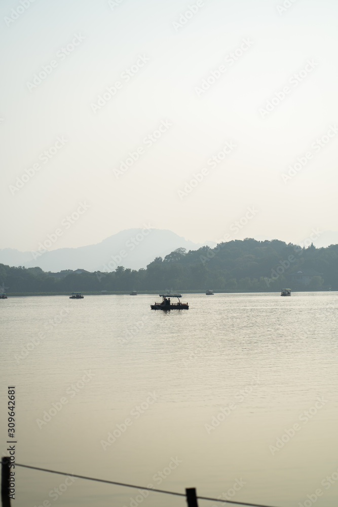 Asian Boat during sunset in Hangzhou West Lake Asian Boat during sunset in Hangzhou West Lake
