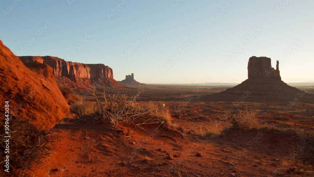 Time Lapse of dawn at Monument Valley. Camera moves past tumbleweeds with the buttes of Monument Valley Arizona in the background. Time Lapse of dawn at Monument Valley. Camera moves past tumbleweeds with the buttes of Monument Valley Arizona in the background.