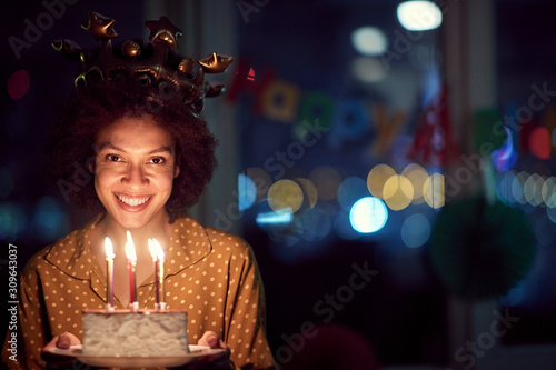 Smiling birthday girl holding birthday cake