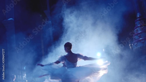 Classic ballet ballerina dancing on stage on Pointe photo