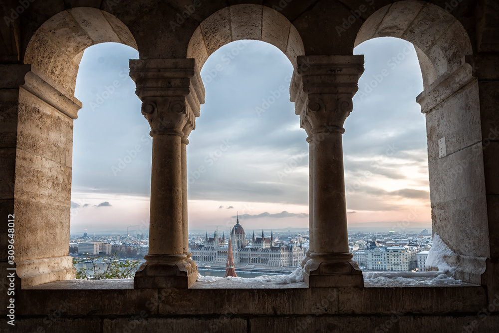 Panoramic view of Budapest through the windows of the Fisherman's Bastion at dawn in winter Panoramic view of Budapest through the windows of the Fisherman's Bastion at dawn in winter
