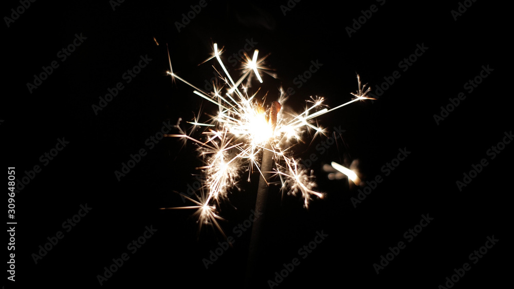 Close-up of firework sparkler burning. Fireworks burn on a black background