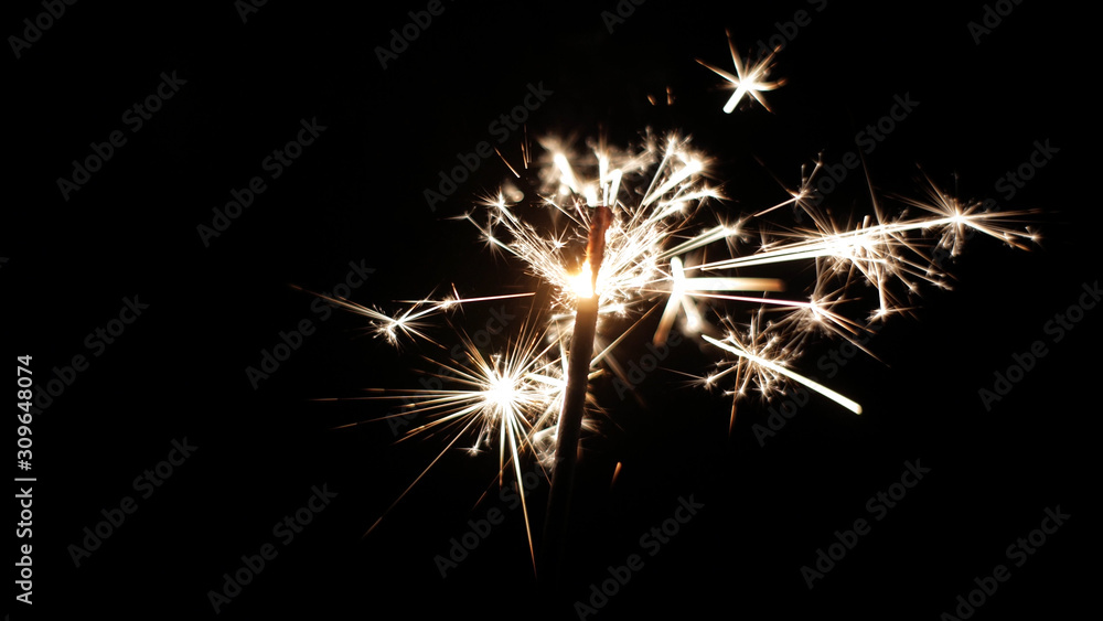 Close-up of firework sparkler burning. Fireworks burn on a black background