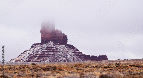 The top of the Big Chief at Monument Valley Navajo Tribal Park disappears in the low hanging clouds