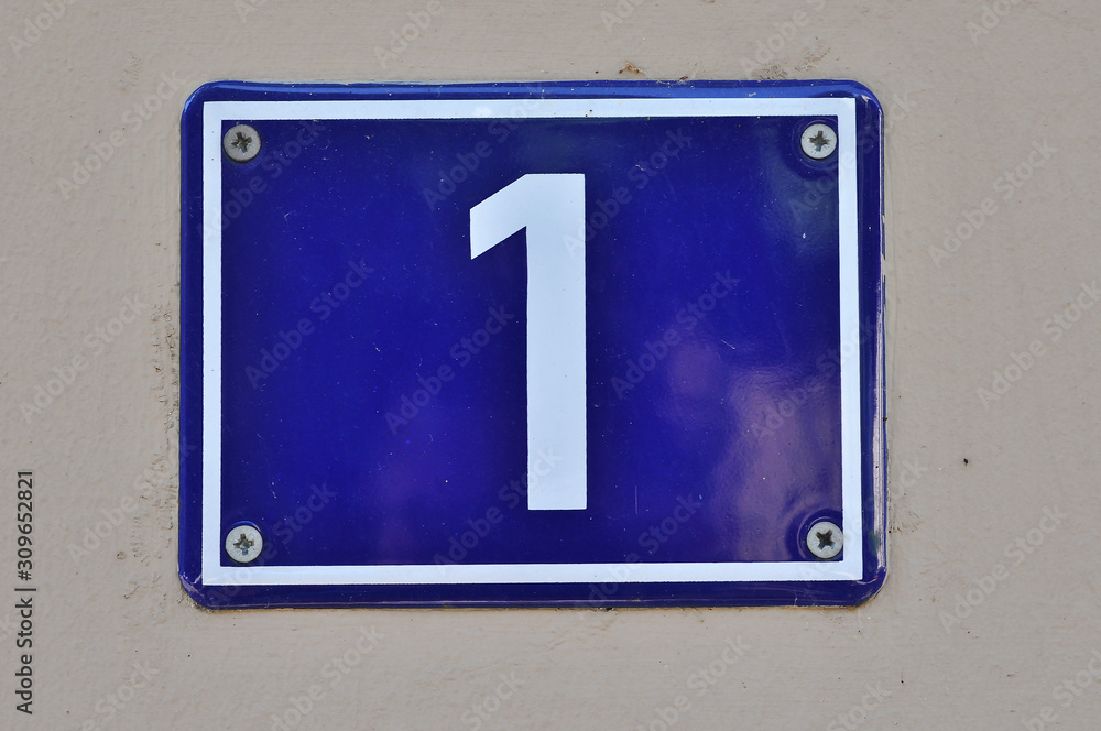 A house number plaque, showing the number one (1) A house number plaque, showing the number one (1)
