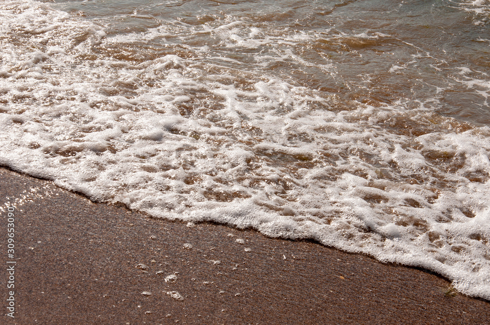 Black Sea. Water with waves. Mainly cloudy weather and sun rays. Blue and grey clouds. Before rain. Sand coast Black Sea. Water with waves. Mainly cloudy weather and sun rays. Blue and grey clouds. Before rain. Sand coast