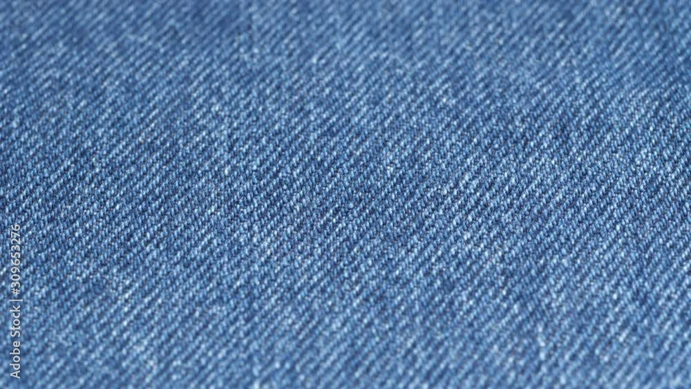 Tracking over jeans fabric plain surface, low angle. Shallow DOF, focus at center. Denim textile. Slider shot. 4K 422 10 bit Tracking over jeans fabric plain surface, low angle. Shallow DOF, focus at center. Denim textile. Slider shot. 4K 422 10 bit