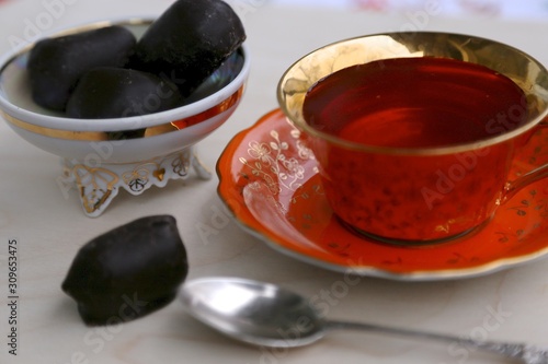 Hot tea cup and chocolate candy