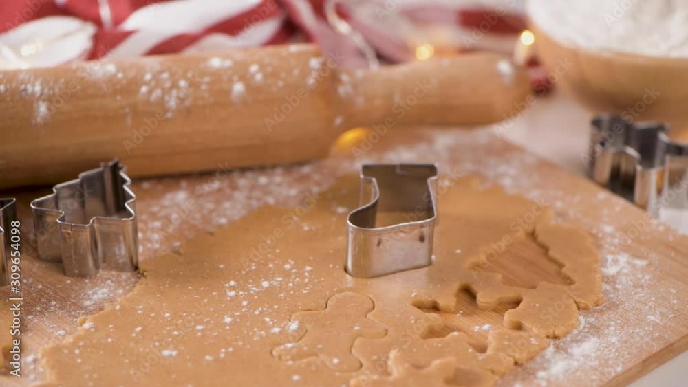 Raw dough for Christmas cookies and cookie cutters on kitchen countertop. Raw dough for Christmas cookies and cookie cutters on kitchen countertop.