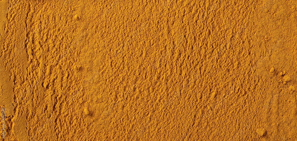 Turmeric powder background and texture Turmeric powder background and texture
