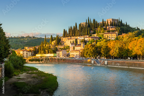Verona cityscape during late sunset with Adige river and Church Complesso della Cattedrale-Duomo, viewed from the opposite side of river. Verona is located in Veneto, Italy,