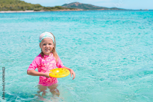 Portrait of adorable little girl at beach on her summer vacation