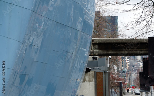 Blue round wall and monorail framing Thomas Street in Seattle Center