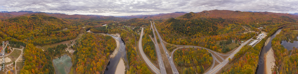 Interstate Highway 93 at Exit 30 with US Route 3 and Pemigewasset River in White Mountain National Forest panorama aerial view with fall foliage, Town of Thornton, New Hampshire NH, USA.