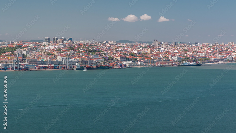 Fototapeta premium Panorama of Lisbon historical centre aerial timelapse viewed from above the southern margin of the Tagus or Tejo River.