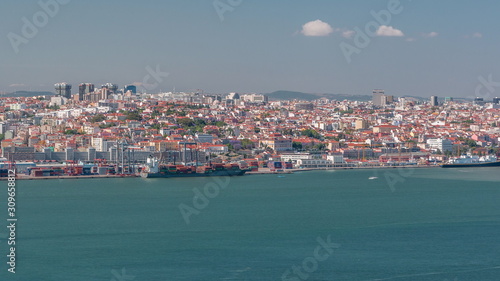 Panorama of Lisbon historical centre aerial timelapse viewed from above the southern margin of the Tagus or Tejo River.