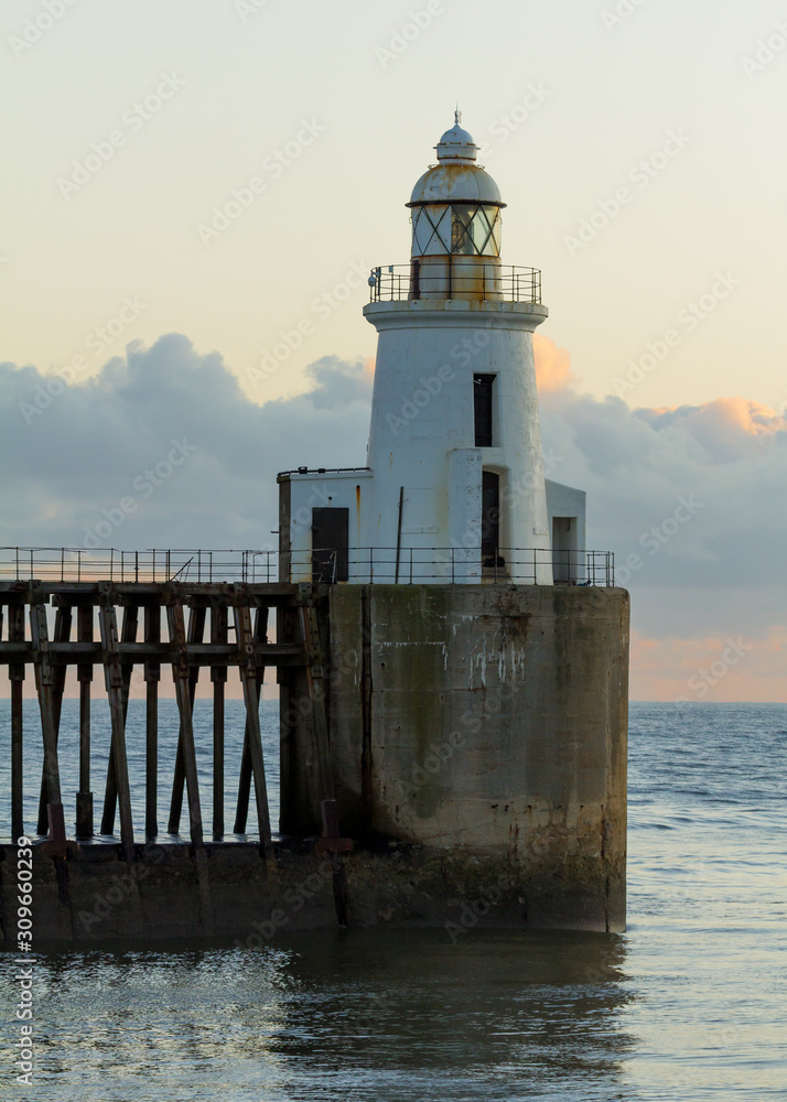 View of Blyth Harbour Piers, Blyth on the coast of Northumberland, England, UK. At sunrise on a winter morning.