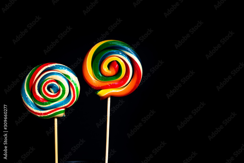 Colored lollipop on black background Colored lollipop on black background
