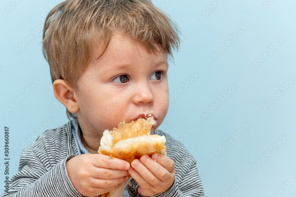 A one-year-old boy eats Traditional Serbian cheese pie gibanica alone A one-year-old boy eats Traditional Serbian cheese pie gibanica alone