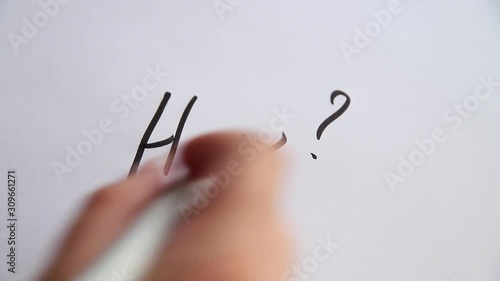 Hand writing How? on white paper photo