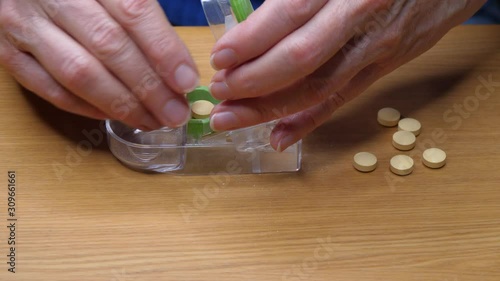 Cutting yellow pills in half with a pill cutter - no sound 4K