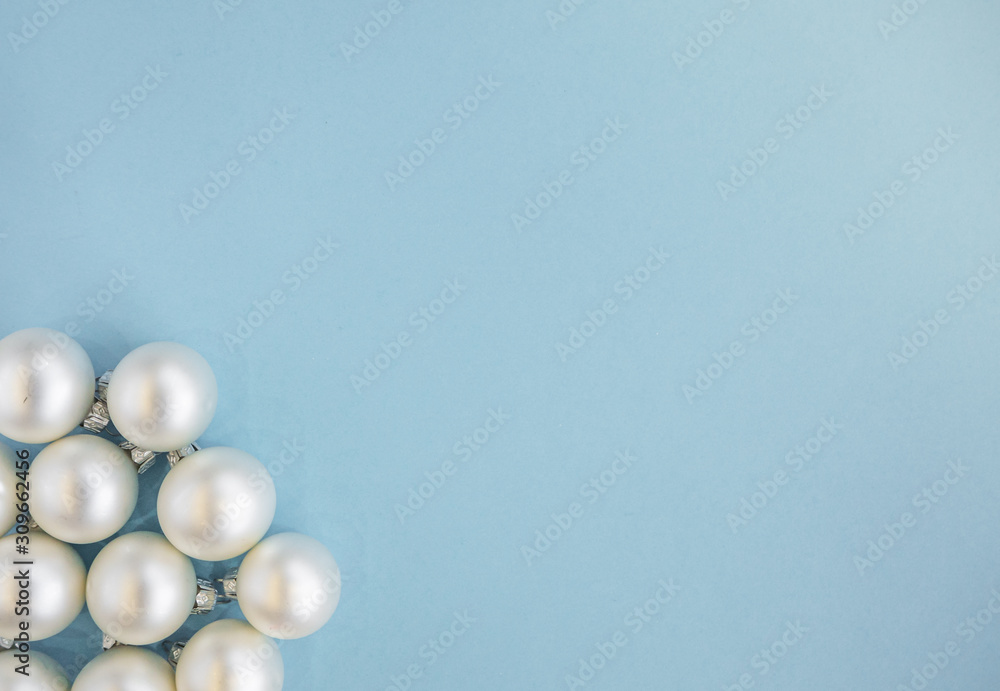 Christmas or new year flat lay with white balls on light blue background. Top view, copy space. Christmas or new year flat lay with white balls on light blue background. Top view, copy space.